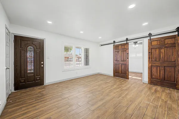 a view of empty room with wooden floor and cabinet