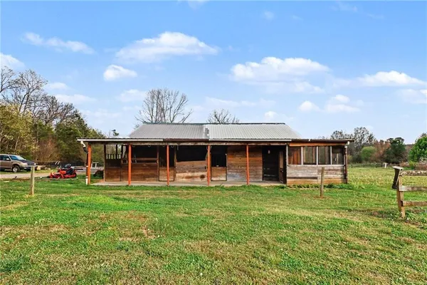 a view of a house with a yard and sitting area