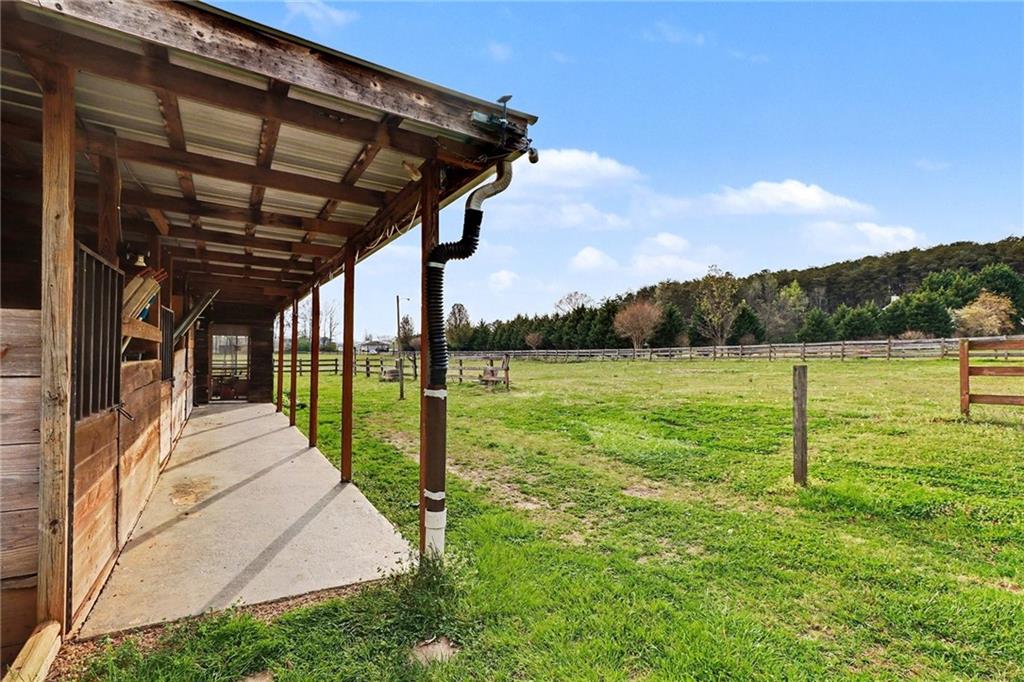 151 Sugar Hill Road Rydal, GA 30171 - Photo 2 of 15 a view of a backyard with a garden and lake view