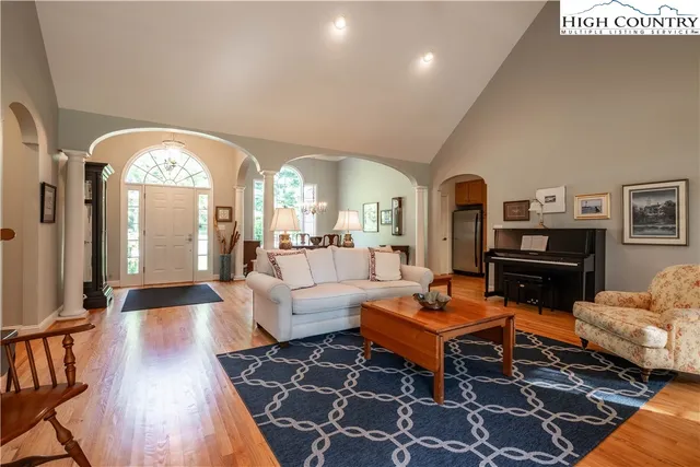 a living room with furniture fireplace and a large window