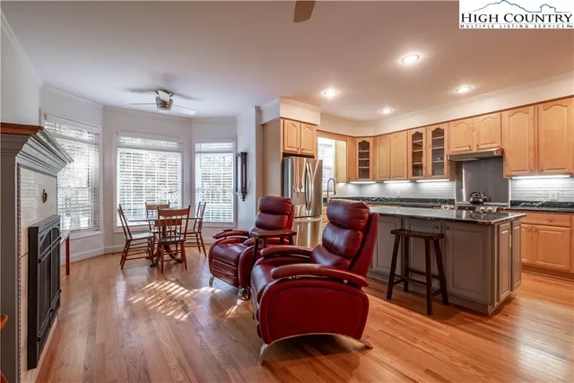 a living room with furniture and a dining table with kitchen view