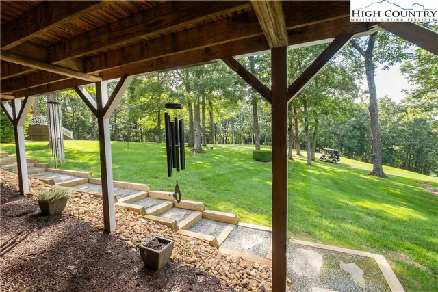 a view of a porch with furniture and backyard