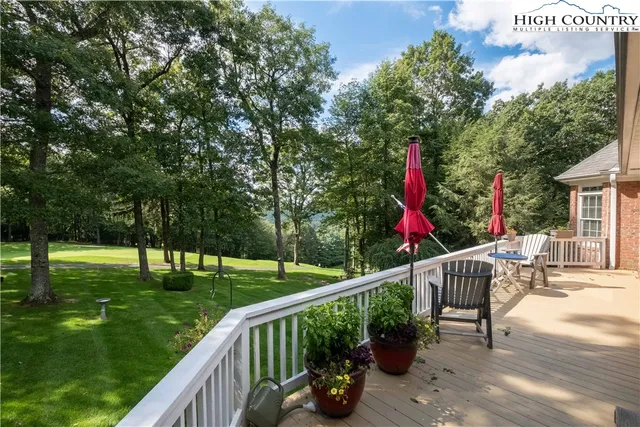 a view of a two chairs and table in the deck