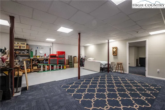 a living room with lots of furniture and a rug