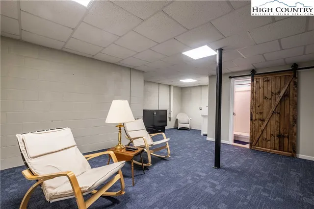 a living room with furniture and a lamp