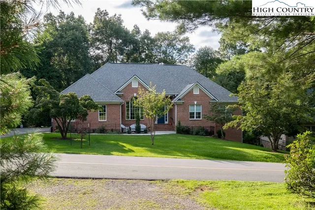 a house that has a tree in front of it