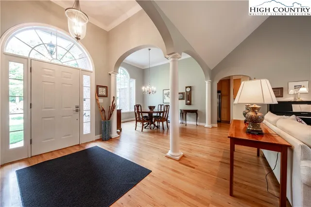 a living room with fireplace furniture and a wooden floor