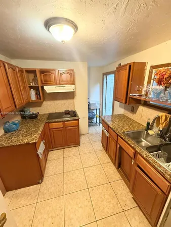 a kitchen with stainless steel appliances granite countertop a stove and a sink