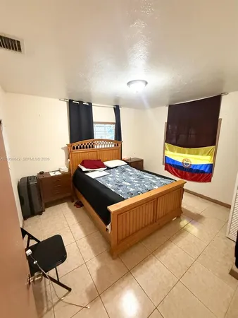a bedroom with a bed and couch
