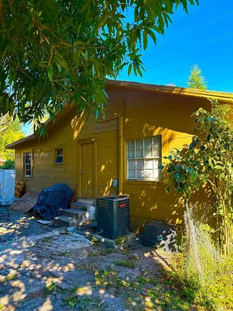 a view of a house with a backyard