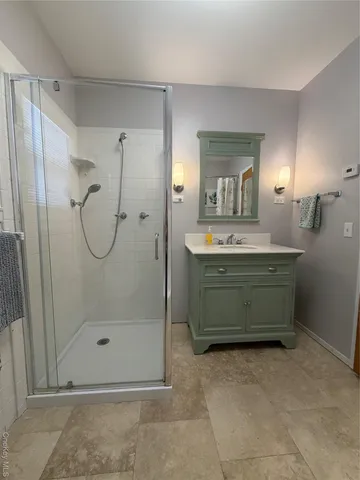 a bathroom with a mirror sink and shower