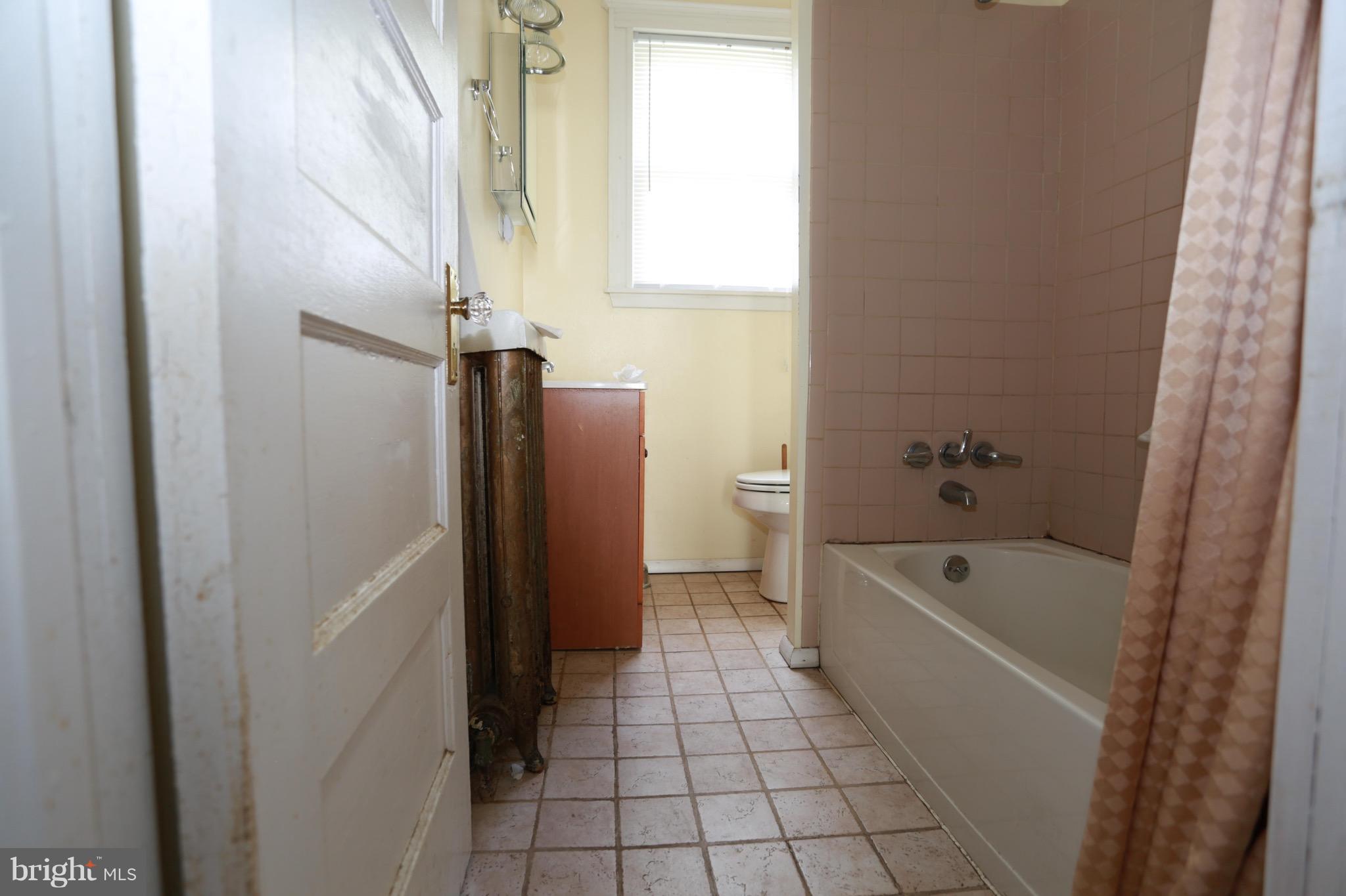 2317 Monticello Road Baltimore, MD 21216 - Photo 11 of 30 a bathroom with a bathtub a toilet and a shower