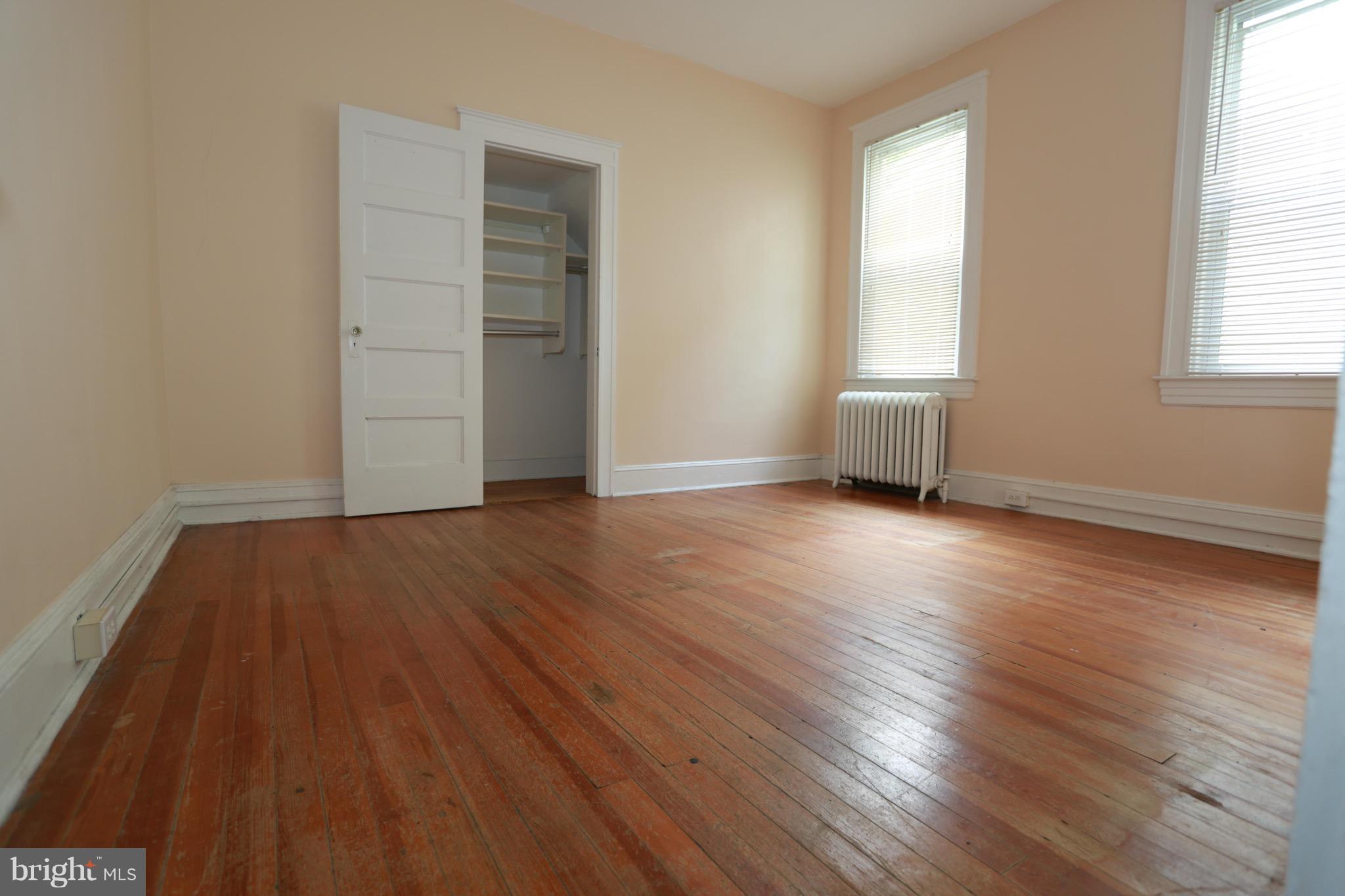 2317 Monticello Road Baltimore, MD 21216 - Photo 13 of 30 an empty room with wooden floor and windows