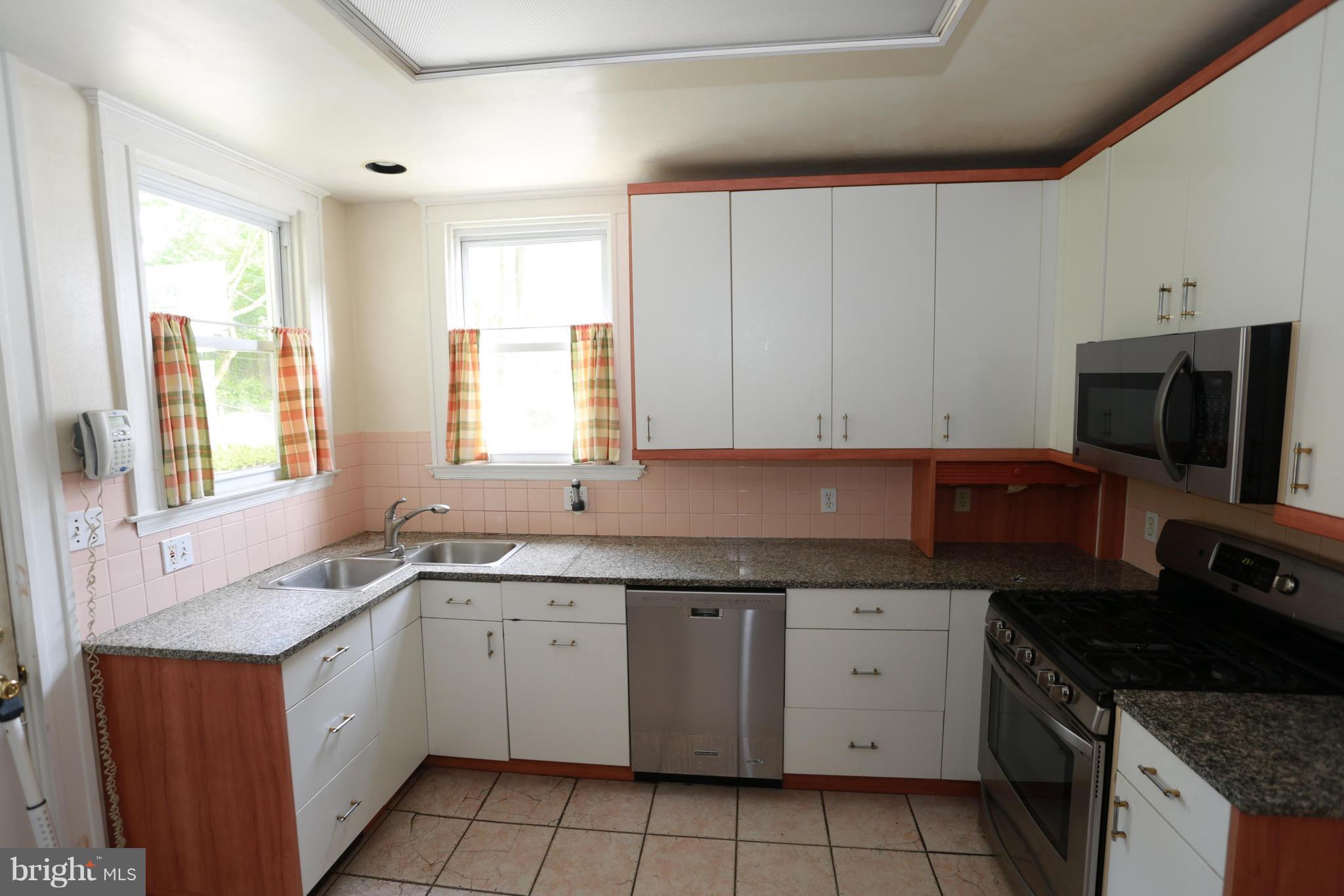 2317 Monticello Road Baltimore, MD 21216 - Photo 15 of 30 a kitchen with a sink stove and cabinets