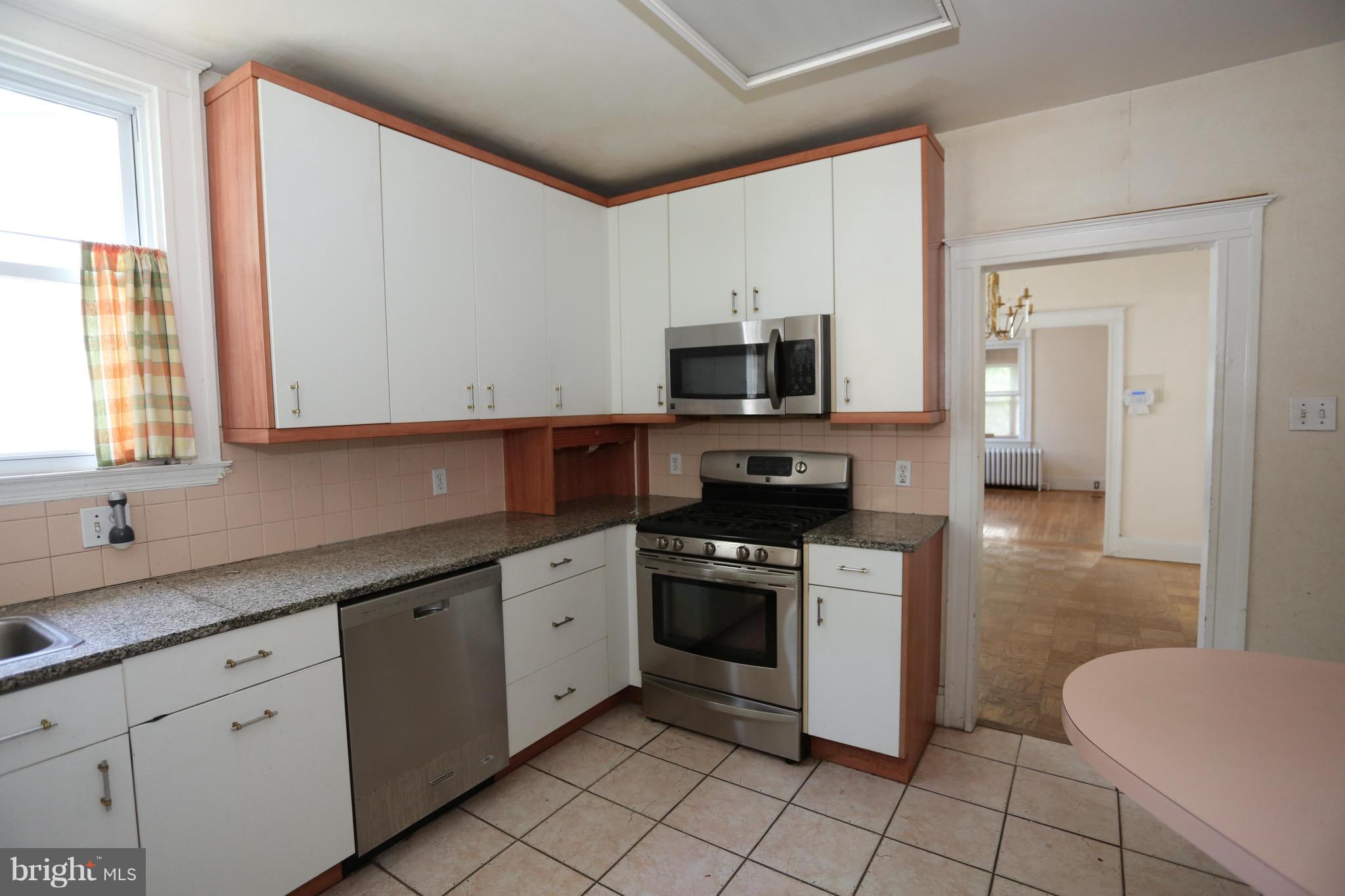 2317 Monticello Road Baltimore, MD 21216 - Photo 17 of 30 a kitchen with stainless steel appliances a stove sink and microwave