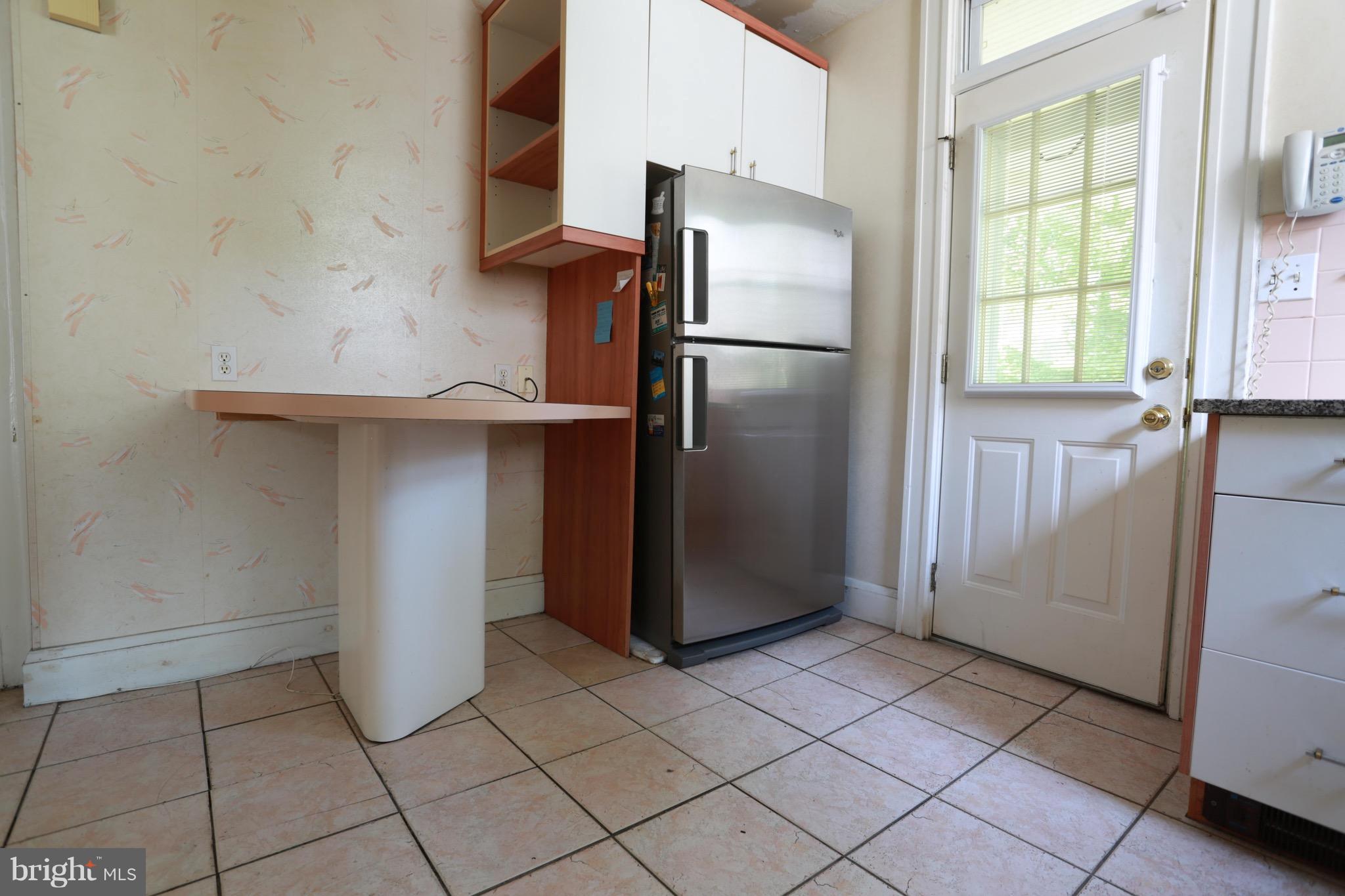 2317 Monticello Road Baltimore, MD 21216 - Photo 18 of 30 a kitchen with a refrigerator and cabinets