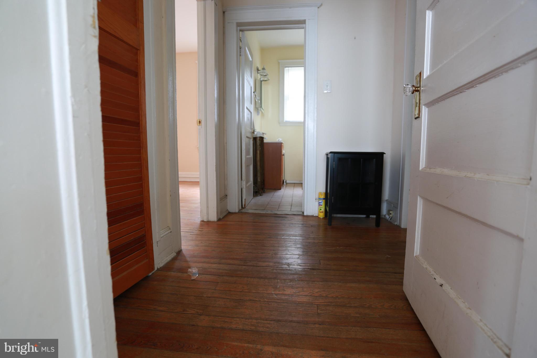 2317 Monticello Road Baltimore, MD 21216 - Photo 21 of 30 a view of a hallway view with wooden floor and staircase