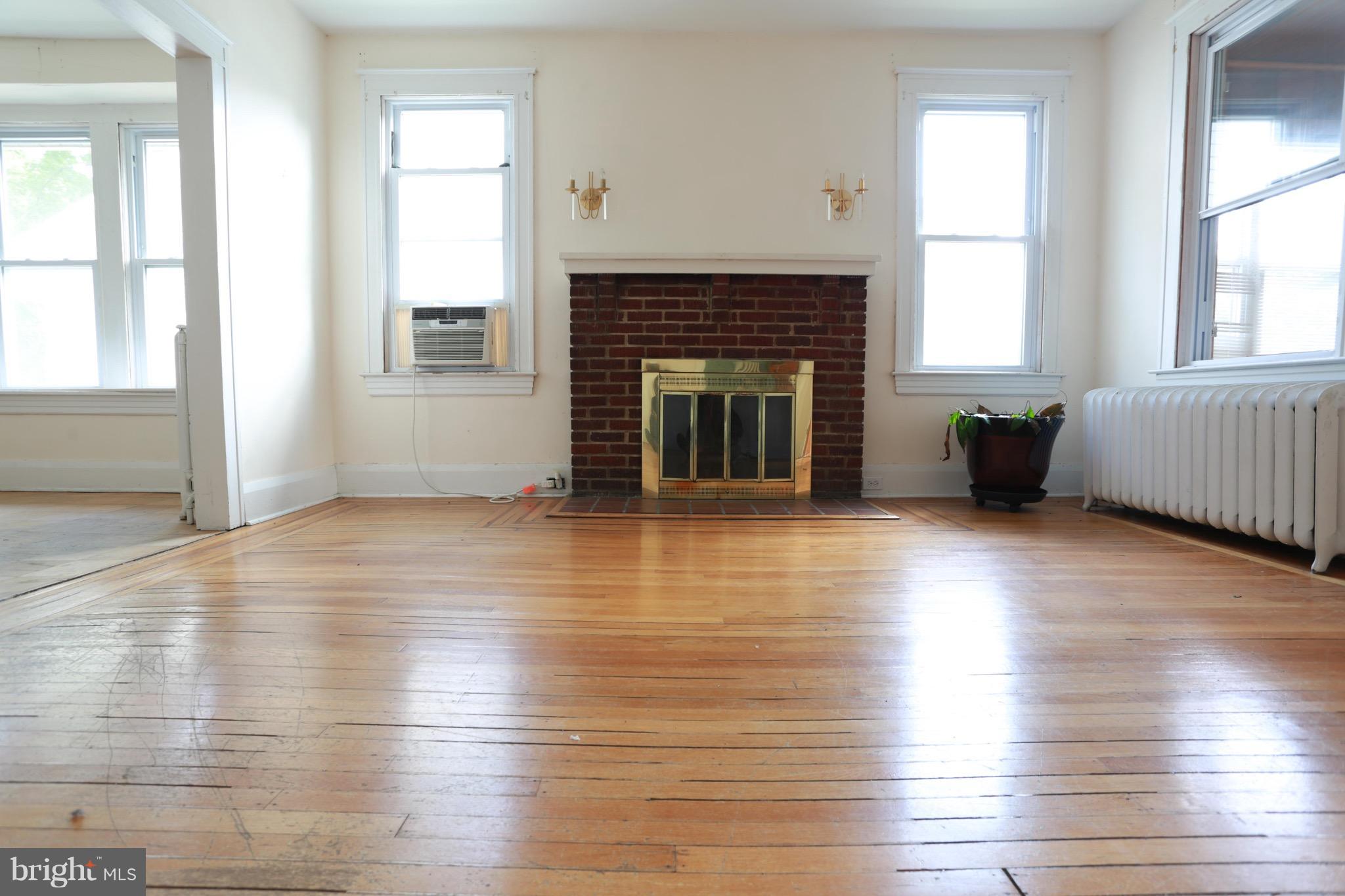 2317 Monticello Road Baltimore, MD 21216 - Photo 22 of 30 an empty room with wooden floor and windows