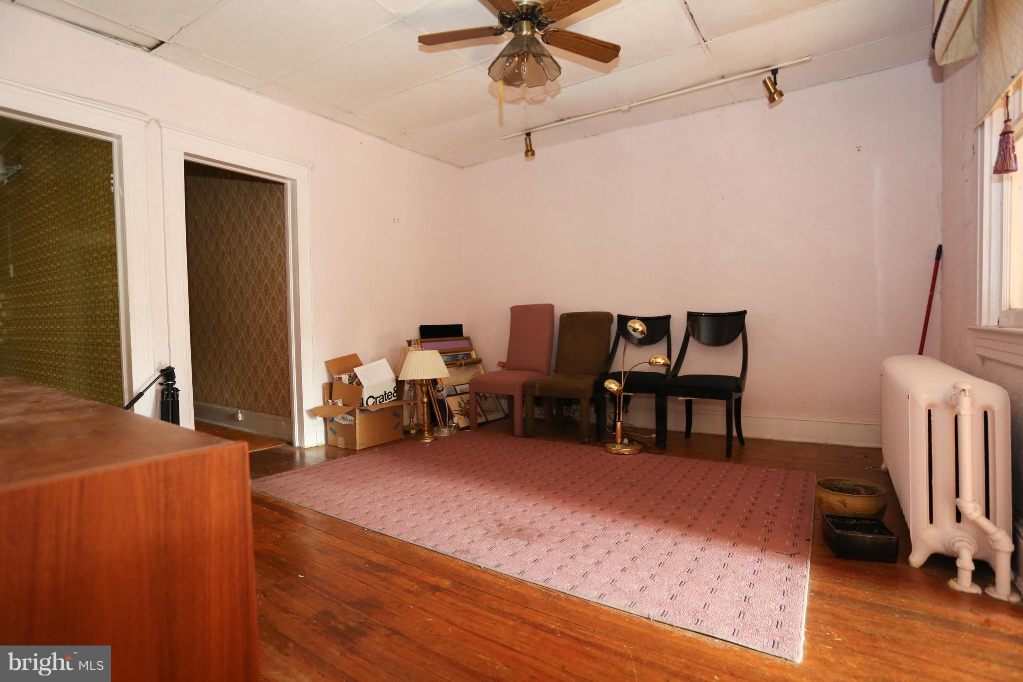 2317 Monticello Road Baltimore, MD 21216 - Photo 23 of 30 a living room with furniture a ceiling fan and a rug