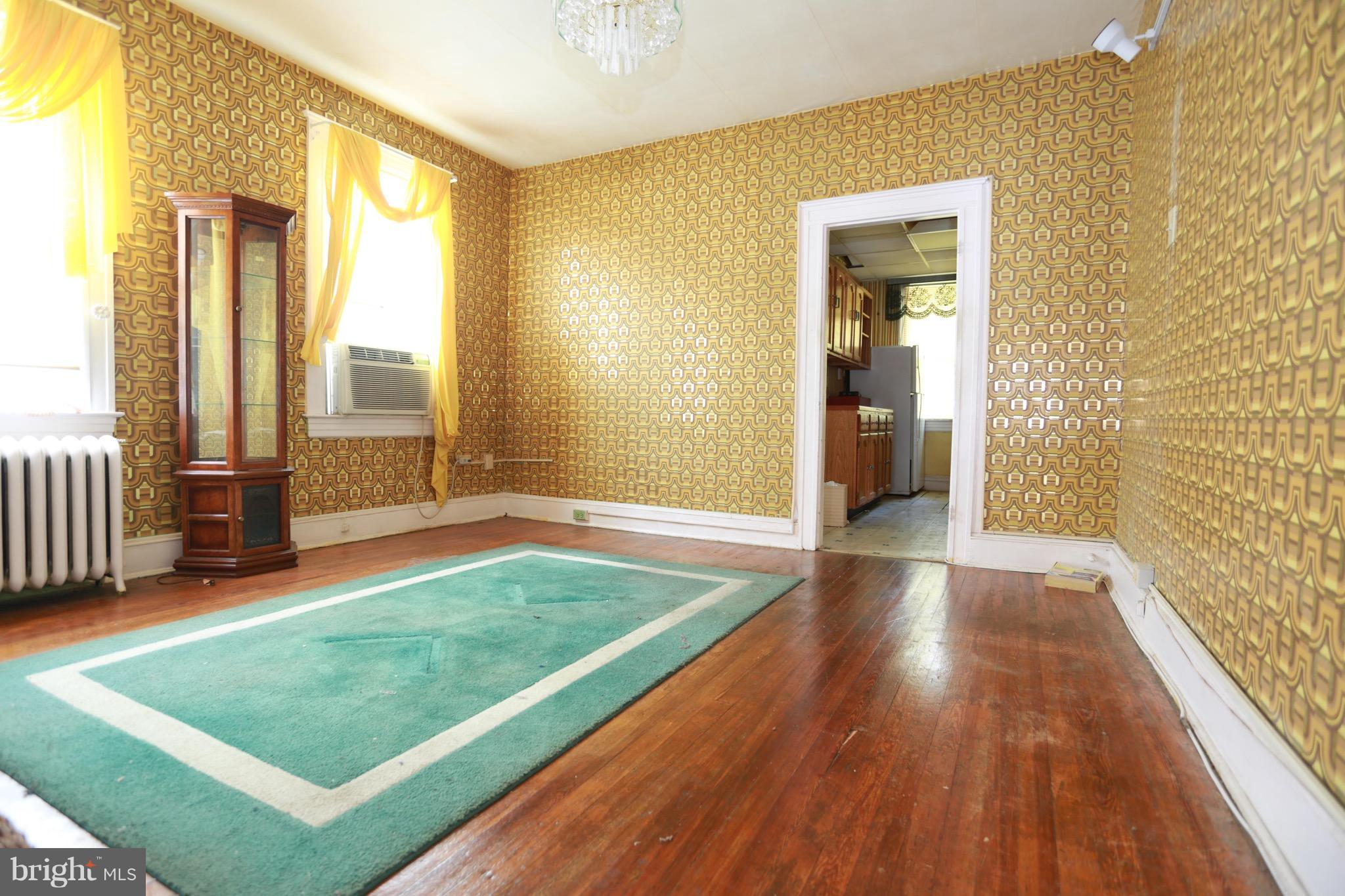 2317 Monticello Road Baltimore, MD 21216 - Photo 26 of 30 a view of an empty room with glass door and wooden floor