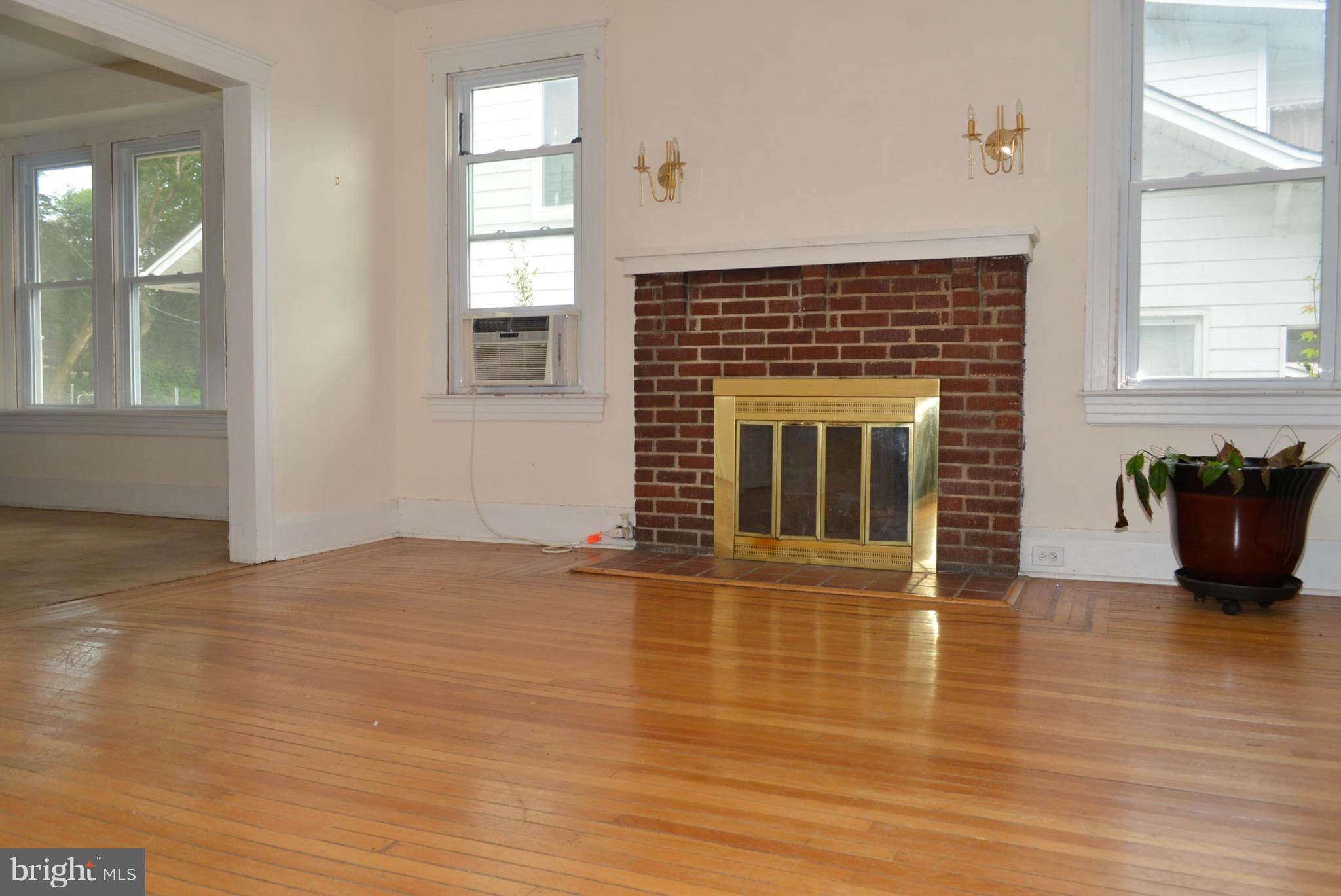 2317 Monticello Road Baltimore, MD 21216 - Photo 5 of 30 a view of an empty room with glass door and wooden floor