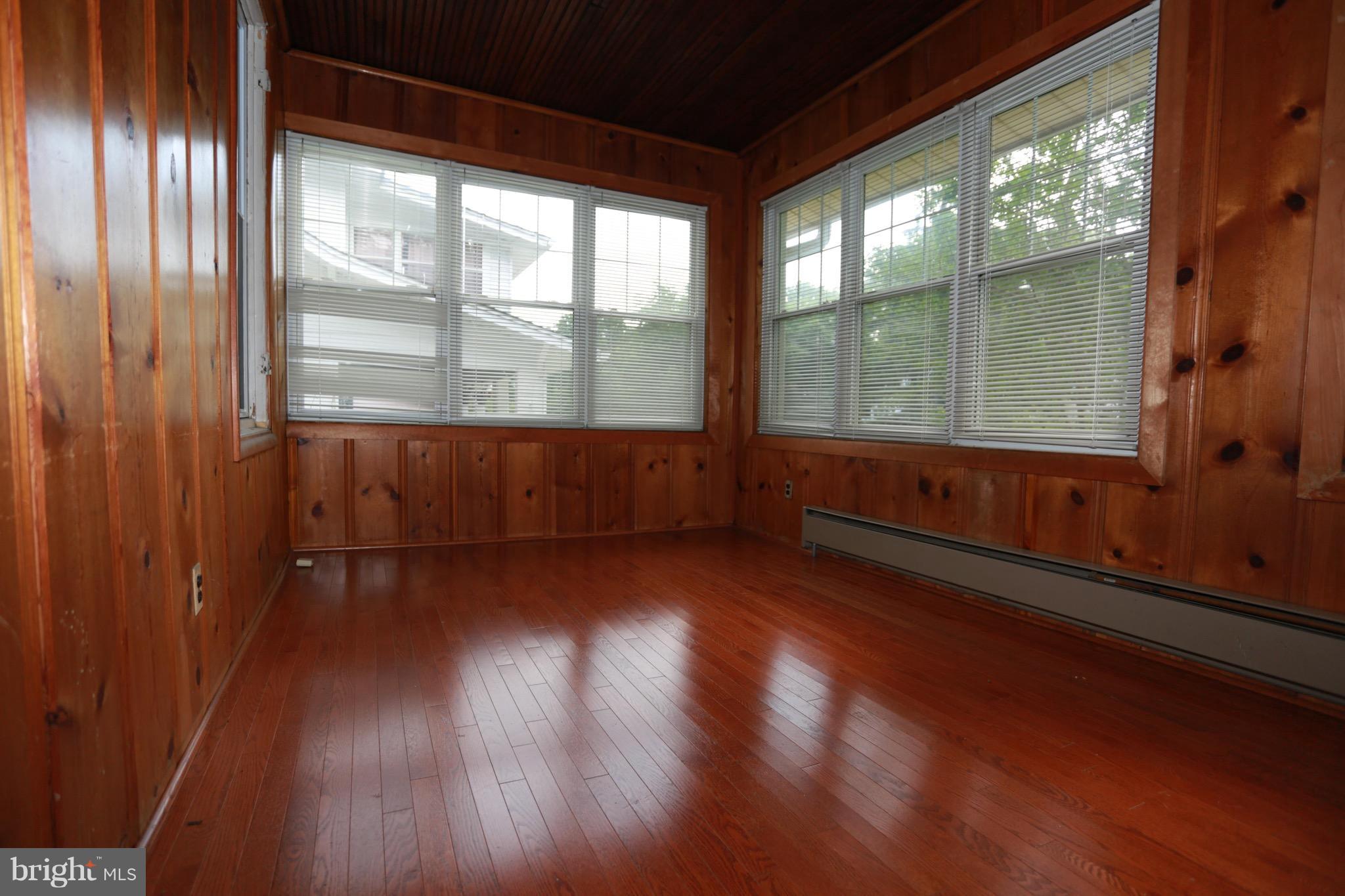 2317 Monticello Road Baltimore, MD 21216 - Photo 6 of 30 an empty room with wooden floor and windows