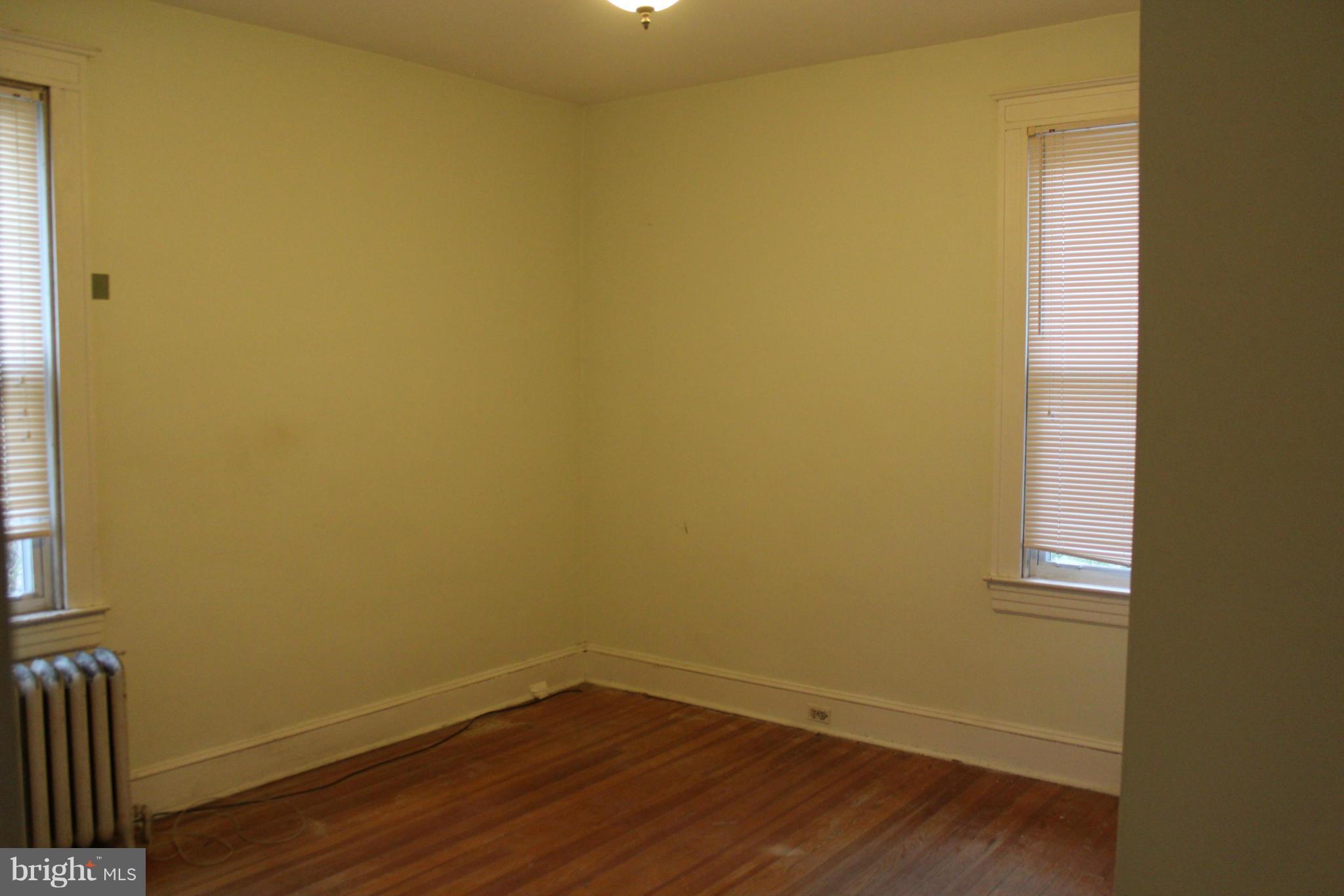 2317 Monticello Road Baltimore, MD 21216 - Photo 8 of 30 a view of a small space with wooden floor and a window