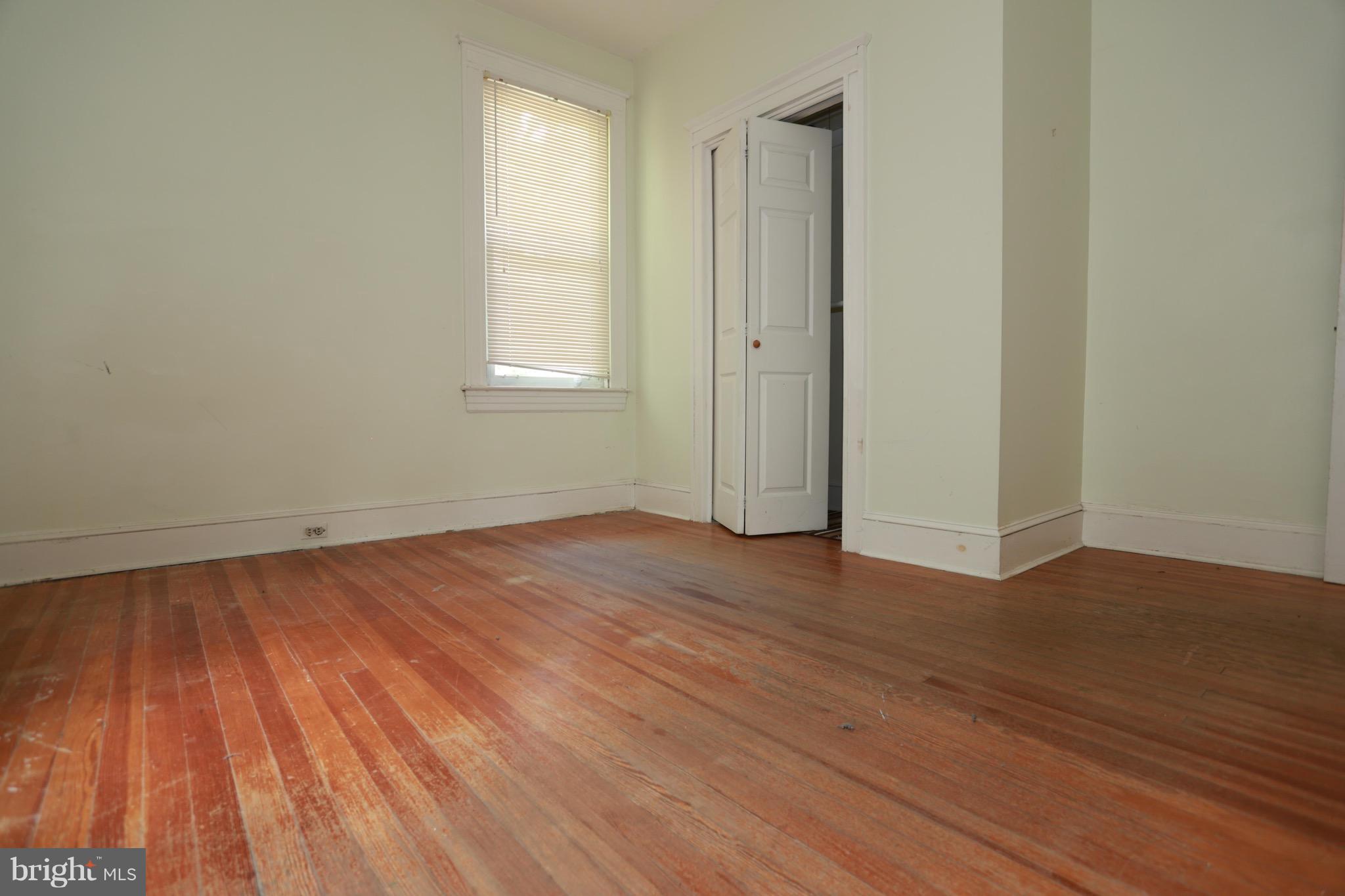 2317 Monticello Road Baltimore, MD 21216 - Photo 10 of 30 a view of a room with wooden floor and window