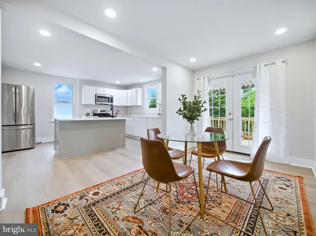 a living room with furniture and large windows