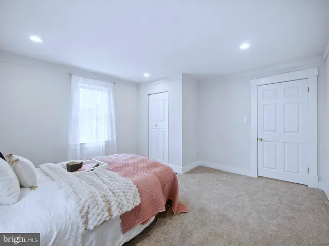 a bed room with a bed and a window