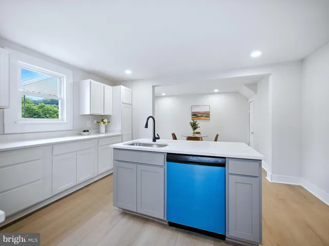 a kitchen with a sink cabinets and window