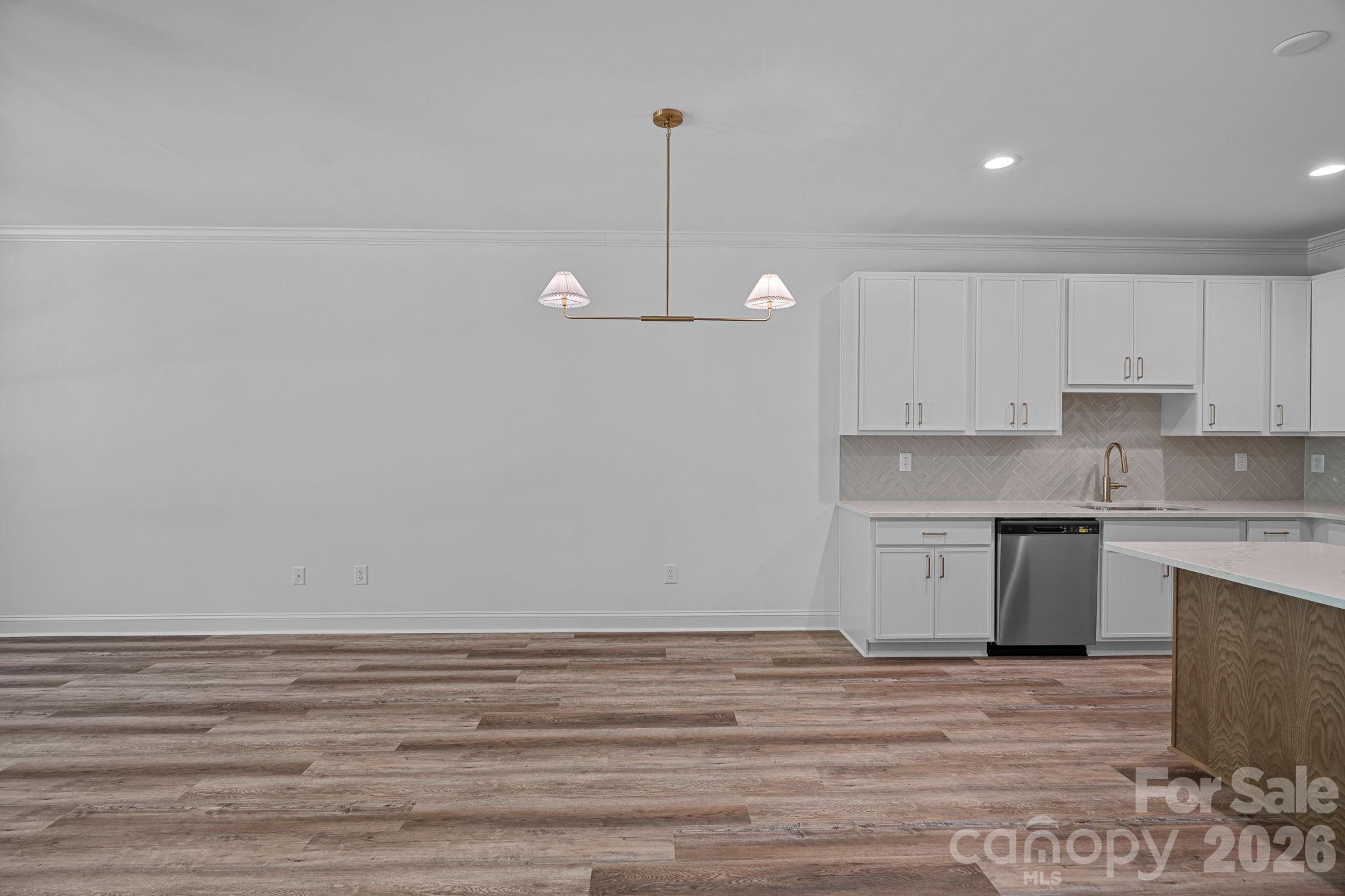 4015 Sofley Road Charlotte, NC 28206 - Photo 13 of 41 a view of a kitchen with white cabinets and wooden floor