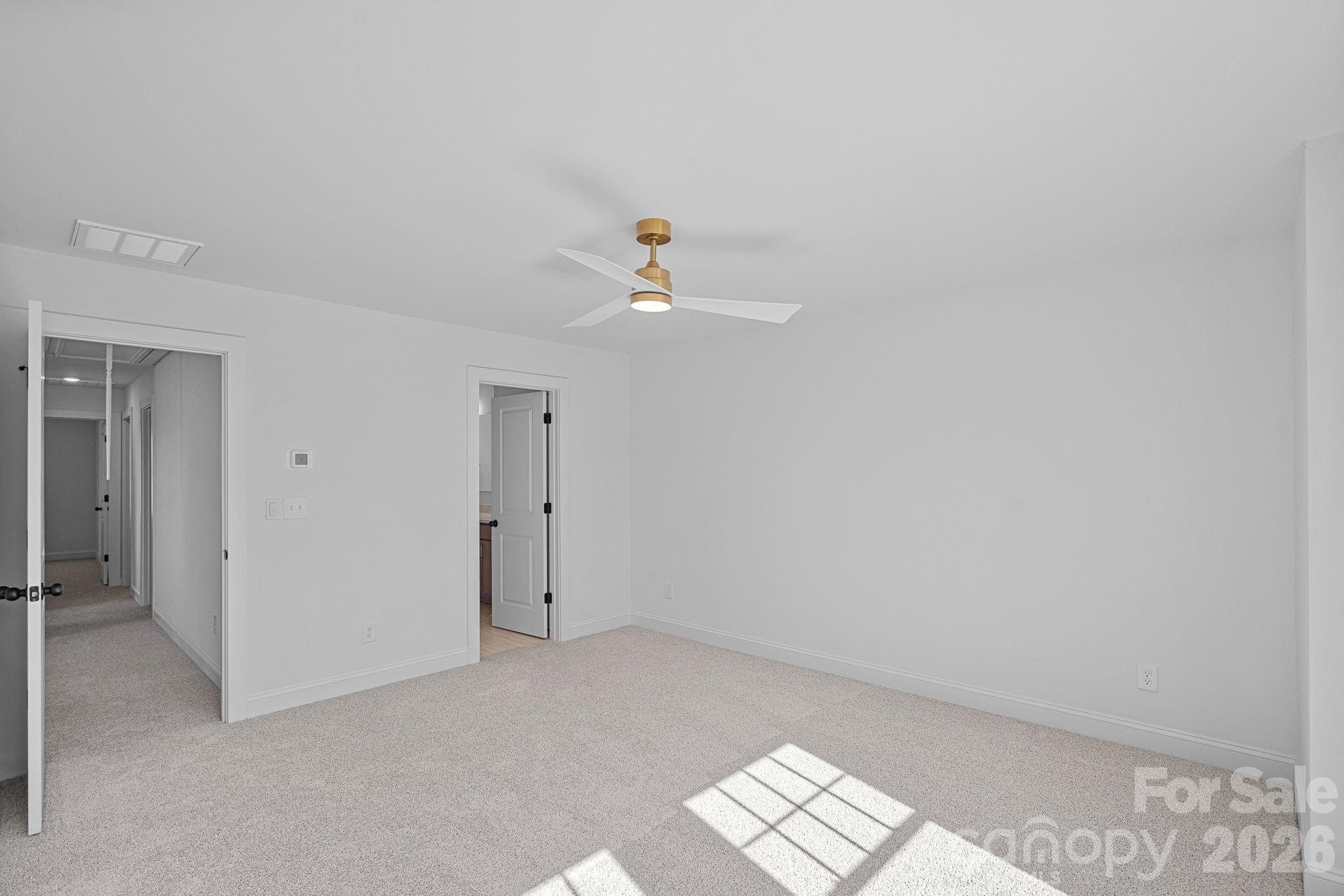 4015 Sofley Road Charlotte, NC 28206 - Photo 25 of 41 a view of an empty room with wooden floor and a ceiling fan