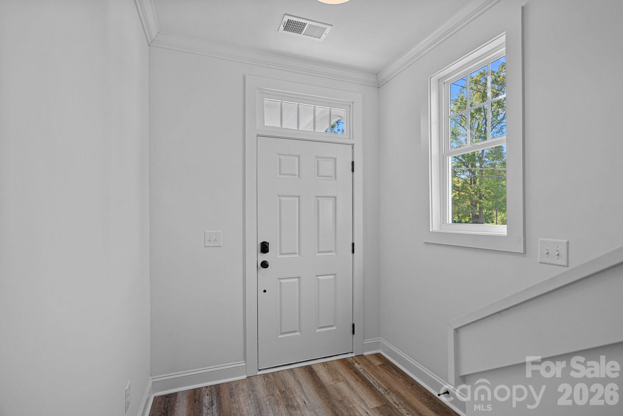4015 Sofley Road Charlotte, NC 28206 - Photo 4 of 41 a view of hallway with window and wooden floor