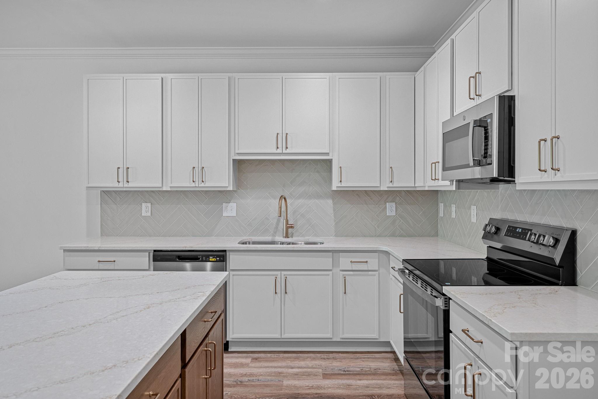 4015 Sofley Road Charlotte, NC 28206 - Photo 7 of 41 a kitchen with stainless steel appliances granite countertop a sink stove and white cabinets