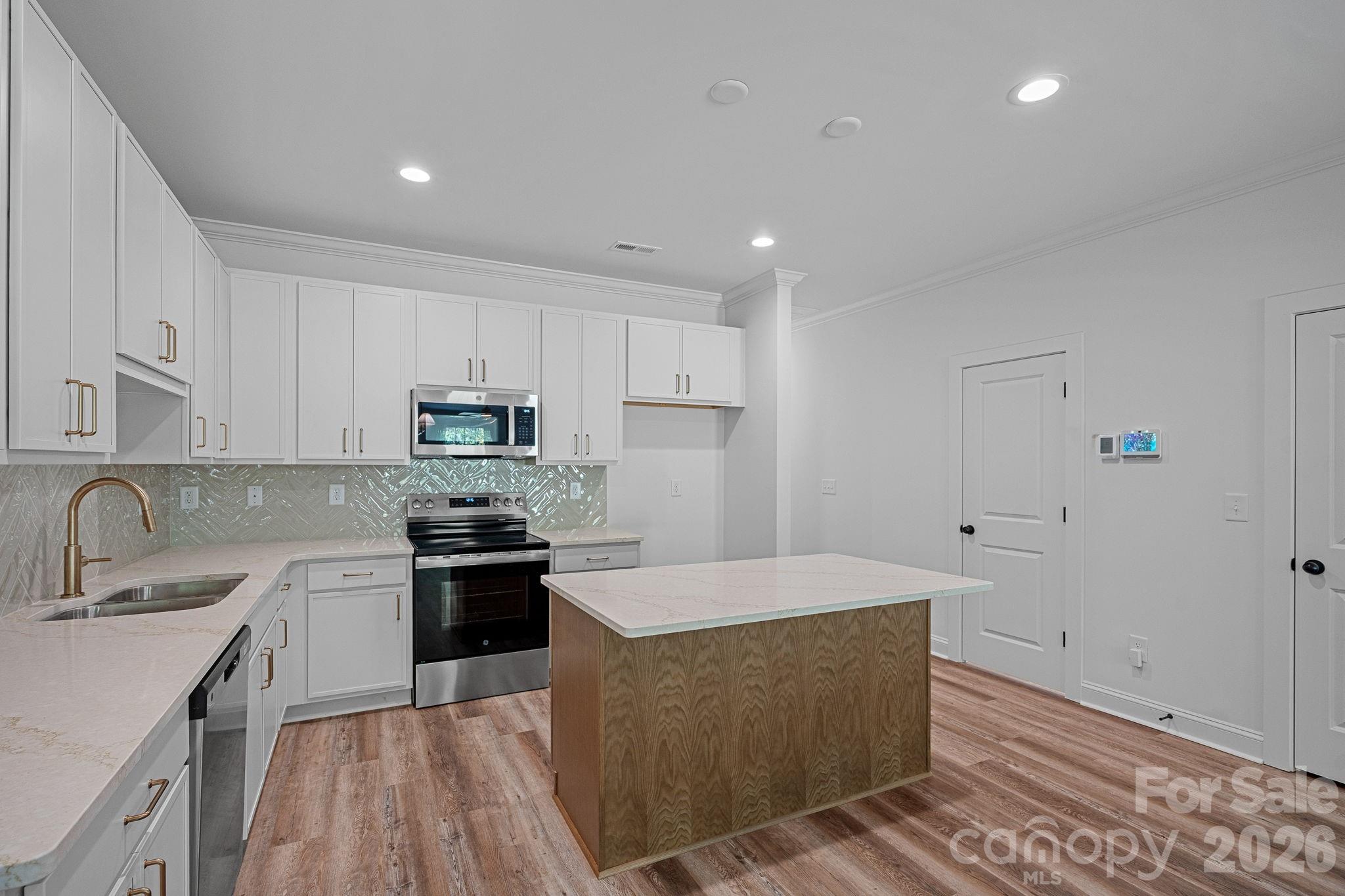 4015 Sofley Road Charlotte, NC 28206 - Photo 8 of 41 a kitchen with stainless steel appliances granite countertop a sink a stove a refrigerator and cabinets