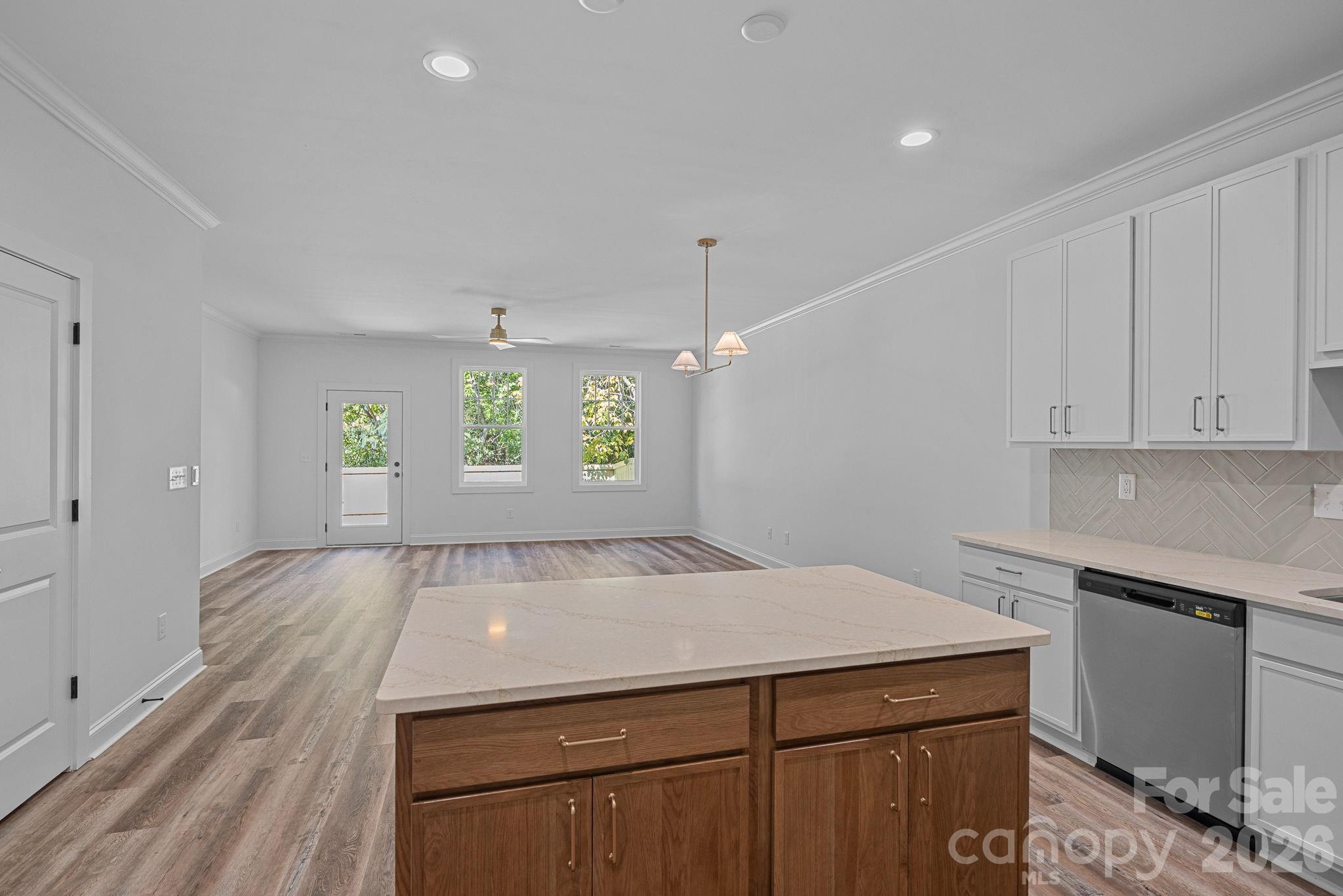 4015 Sofley Road Charlotte, NC 28206 - Photo 10 of 41 a view of a kitchen with a sink and dishwasher with wooden floor