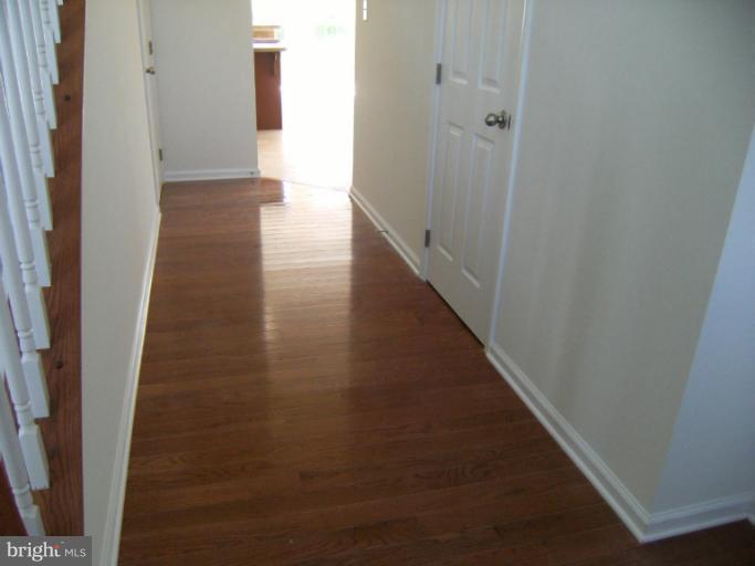 783 Rivanna Run Falling Waters, WV 25419 - Photo 16 of 30 a view of a hallway with wooden floor