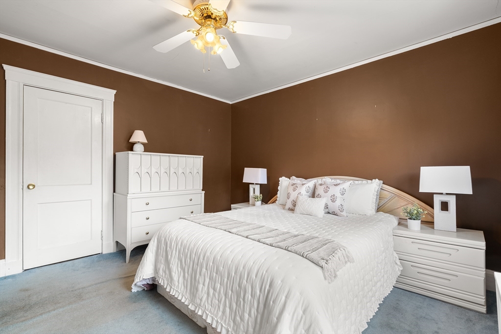 26-28 Alton Street Arlington, MA 02474 - Photo 16 of 41 a bedroom with a bed and a chandelier