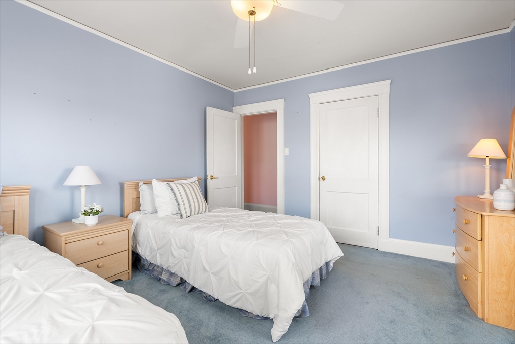 26-28 Alton Street Arlington, MA 02474 - Photo 19 of 41 a bedroom with two beds and a lamp on table