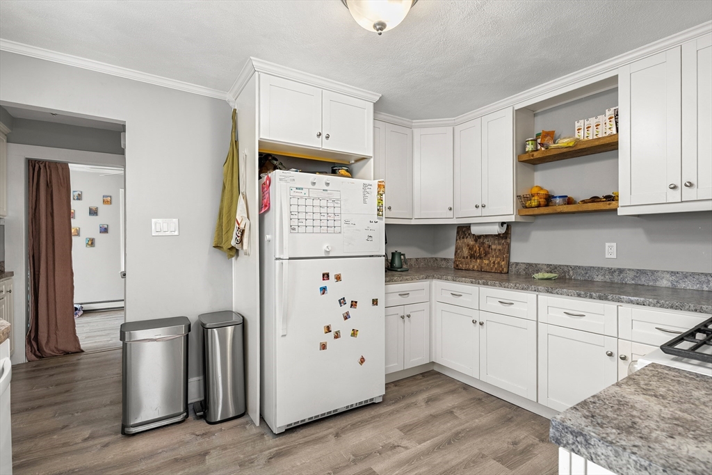 26-28 Alton Street Arlington, MA 02474 - Photo 31 of 41 a kitchen with stainless steel appliances granite countertop a refrigerator and a stove top oven