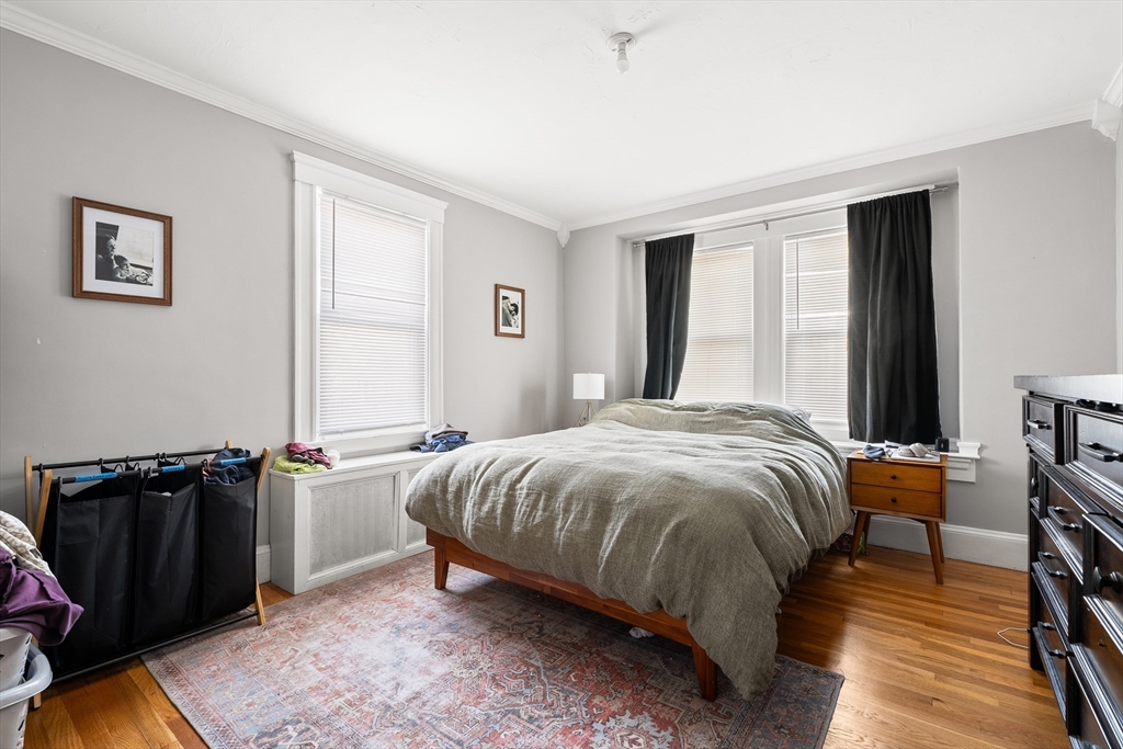 26-28 Alton Street Arlington, MA 02474 - Photo 35 of 41 a bedroom with a bed and wooden floor