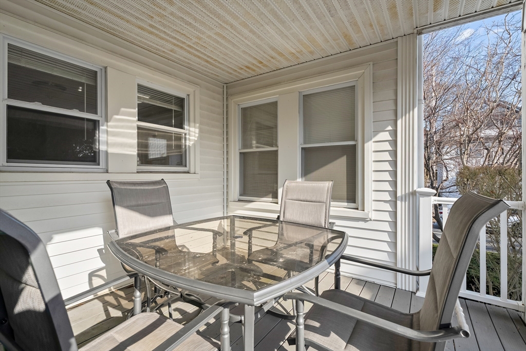 26-28 Alton Street Arlington, MA 02474 - Photo 40 of 41 a patio with table and chairs and potted plants