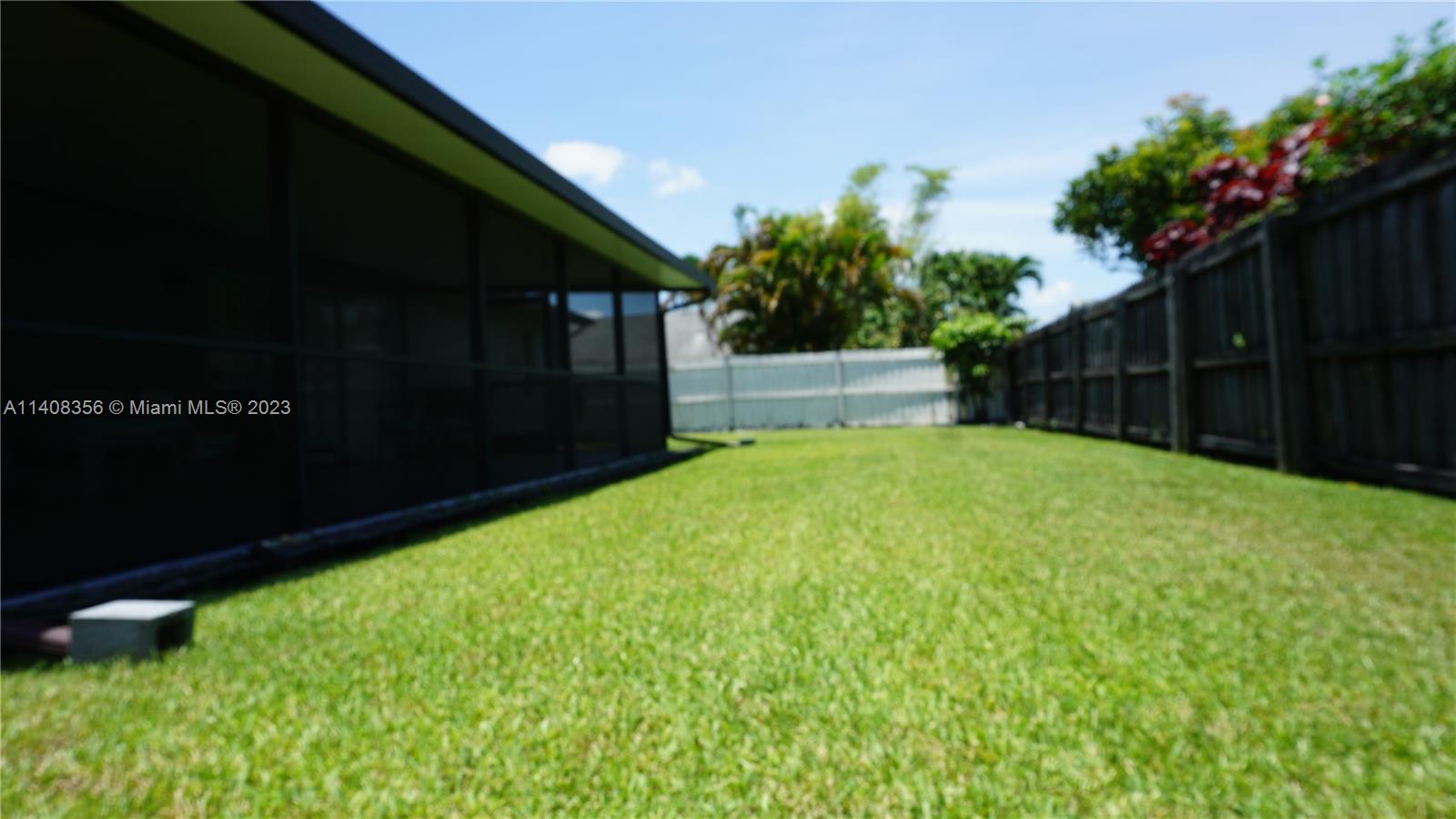 9099 Gettysburg Road Boca Raton, FL 33434 - Photo 17 of 25 a backyard of a house with lots of green space