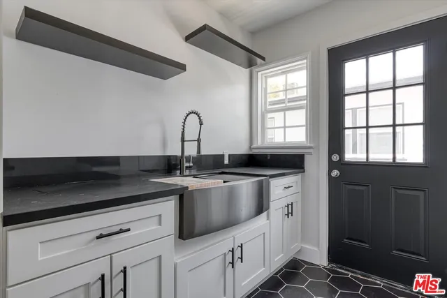 a kitchen with a sink and cabinets