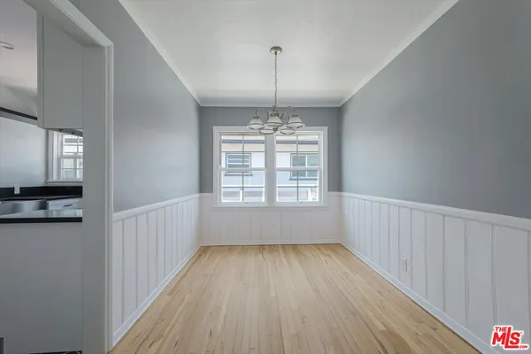 a view of wooden floor and windows in a room
