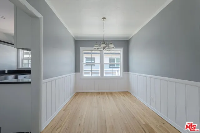 a view of wooden floor and windows in a room