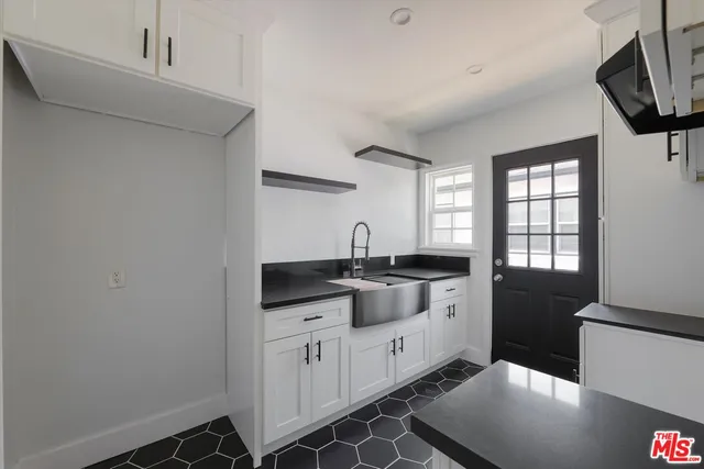 a kitchen with a sink and cabinets