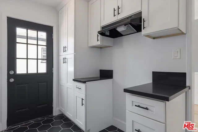 a kitchen with stainless steel appliances a stove and a microwave