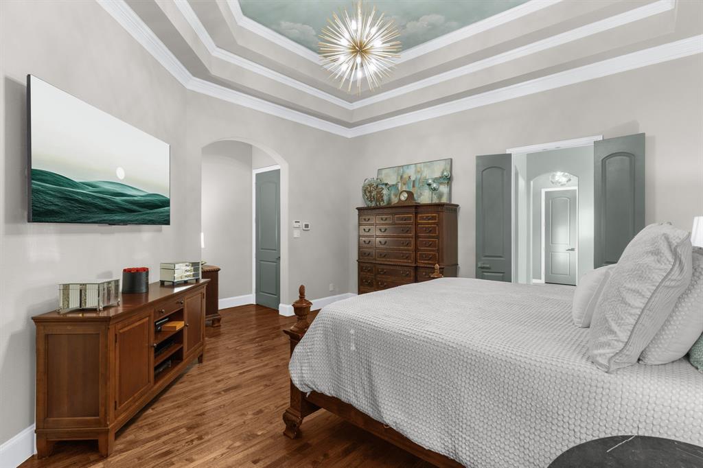 2257 Hermitage Drive Allen, TX 75013 - Photo 22 of 40 a bedroom with a bed and a flat screen tv